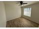 Bright bedroom with wood-look tile flooring and ceiling fan at 4062 W Camino Acequia St, Phoenix, AZ 85051