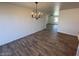 Bright dining room with wood-look tile flooring and chandelier at 4062 W Camino Acequia St, Phoenix, AZ 85051