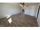 Spacious living room with wood-look tile flooring and ceiling fan at 4062 W Camino Acequia St, Phoenix, AZ 85051