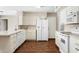 Kitchen with white cabinets, white appliances, and a dishwasher at 4421 W Laurie Ln, Glendale, AZ 85302