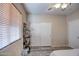 Bedroom with wood-look floors, window blinds, and shelving unit at 46107 W Morning View Ln, Maricopa, AZ 85139