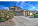 Two-story house with a three-car garage and landscaped front yard at 46107 W Morning View Ln, Maricopa, AZ 85139