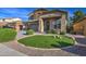 Landscaped front yard with artificial turf and decorative orbs at 46107 W Morning View Ln, Maricopa, AZ 85139