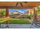 Relaxing covered patio with ceiling fan and comfortable seating area at 46107 W Morning View Ln, Maricopa, AZ 85139