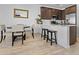 Modern kitchen with dark cabinetry and a breakfast bar at 4717 S Ferric --, Mesa, AZ 85212