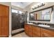 Elegant bathroom with double vanity, granite counters, and shower at 5089 S Harvest St, Gilbert, AZ 85298