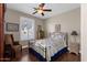 Quaint bedroom with iron bed frame and hardwood floors at 5089 S Harvest St, Gilbert, AZ 85298