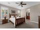 Cozy bedroom with wooden bed frame and plantation shutters at 5089 S Harvest St, Gilbert, AZ 85298