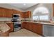 Modern kitchen with granite countertops and stainless steel appliances at 5089 S Harvest St, Gilbert, AZ 85298