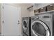 Laundry room with washer, dryer, and built-in shelving at 5089 S Harvest St, Gilbert, AZ 85298