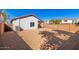 Sun-drenched backyard with gravel and a detached structure at 509 E Daniella Dr, San Tan Valley, AZ 85140