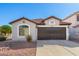 Single story home with dark brown garage door and landscaped yard at 509 E Daniella Dr, San Tan Valley, AZ 85140