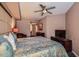 King bed, ceiling fan, and access to bathroom and hallway at 5450 E Deer Valley Dr # 1180, Phoenix, AZ 85054