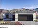 Single-story home with a two-car garage and desert landscaping at 5501 E Rock Bush Ln, San Tan Valley, AZ 85140