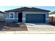 Charming single-story home featuring a two-car garage and low maintenance landscaping at 5501 E Rock Bush Ln, San Tan Valley, AZ 85140