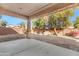 Covered patio with gravel yard and mature trees at 6229 S Moccasin Trl, Gilbert, AZ 85298