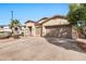 Tan two-story house with a two-car garage and front landscaping at 6229 S Moccasin Trl, Gilbert, AZ 85298