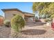 Back exterior of house with desert landscaping at 6229 S Moccasin Trl, Gilbert, AZ 85298