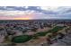 Aerial view of a luxury community with golf course and sunset at 6497 S Twilight Ct, Gilbert, AZ 85298