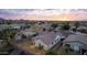 Aerial view of house, backyard, and neighborhood at sunset at 6497 S Twilight Ct, Gilbert, AZ 85298