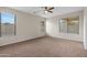 Bright bedroom with large windows and carpet at 6497 S Twilight Ct, Gilbert, AZ 85298