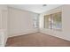 Well-lit bedroom featuring brown carpet and large window at 6497 S Twilight Ct, Gilbert, AZ 85298