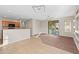 Dining area with tile floor, breakfast bar, and view into living room at 6497 S Twilight Ct, Gilbert, AZ 85298