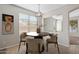 Bright dining area with tile flooring and a modern light fixture at 6497 S Twilight Ct, Gilbert, AZ 85298