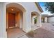 Front entrance with arched entryway and red door at 6497 S Twilight Ct, Gilbert, AZ 85298