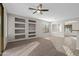 Living room with built-in shelving and a ceiling fan at 6497 S Twilight Ct, Gilbert, AZ 85298