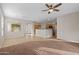 Open concept living room and kitchen with tile and carpet flooring at 6497 S Twilight Ct, Gilbert, AZ 85298