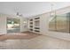 Bright living room with tile floors, a sliding glass door, and built-in shelving at 6497 S Twilight Ct, Gilbert, AZ 85298