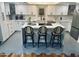 Modern kitchen with white cabinets and an island at 7028 N Barbados Pl, Phoenix, AZ 85021