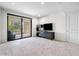 Bright bedroom with plush carpet, large sliding door to balcony, and built-in shelving at 7175 E Camelback Rd # 207, Scottsdale, AZ 85251