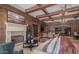 Spacious common area with a fireplace, comfortable seating, and wood beams at 7175 E Camelback Rd # 207, Scottsdale, AZ 85251