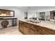 Modern kitchen with granite countertops, stainless steel sink, and wooden cabinetry at 7175 E Camelback Rd # 207, Scottsdale, AZ 85251