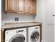 Bright laundry room, featuring a washer and dryer, and ample cabinets at 7175 E Camelback Rd # 207, Scottsdale, AZ 85251