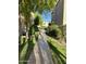 Landscaped walkway between condo buildings with mature trees at 7510 E Thomas Rd # 134, Scottsdale, AZ 85251