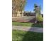 Community tennis court with green surface and surrounding landscaping at 7510 E Thomas Rd # 134, Scottsdale, AZ 85251