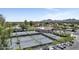 Aerial view of multiple tennis courts, a clubhouse, and mountain views in a vibrant community setting at 7705 E Doubletree Ranch Rd # 55, Scottsdale, AZ 85258