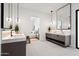 Sleek bathroom with floating vanities, pendant lighting, and a view into the bedroom, creating a spa-like ambiance at 8255 E Morgan Trl, Scottsdale, AZ 85258