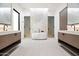 Bright bathroom with double vanity, freestanding tub, marble accent wall, and modern fixtures at 8255 E Morgan Trl, Scottsdale, AZ 85258