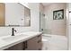 Modern bathroom features a sleek vanity, bathtub with shower, and tiled walls at 8255 E Morgan Trl, Scottsdale, AZ 85258