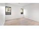 Minimalist bedroom with hardwood floors, neutral tones, and ample natural light from well-placed windows at 8255 E Morgan Trl, Scottsdale, AZ 85258