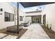 Elegant courtyard featuring tiled flooring, a minimalist seating area, and a trellis at 8255 E Morgan Trl, Scottsdale, AZ 85258