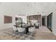 Open-concept living space with a modern dining set and an island kitchen with statement pendant lights at 8255 E Morgan Trl, Scottsdale, AZ 85258