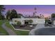 Stunning home boasts a clean, modern design with beautiful landscaping and a spacious driveway at 8255 E Morgan Trl, Scottsdale, AZ 85258