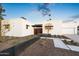 Contemporary exterior showcasing the modern design, desert landscaping, and a well-lit walkway leading to the entrance at 8255 E Morgan Trl, Scottsdale, AZ 85258