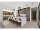 Kitchen island with counter seating, stylish pendants, and high-end cabinetry at 8255 E Morgan Trl, Scottsdale, AZ 85258