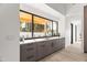 This modern kitchen features sleek cabinetry, a large window overlooking the backyard, and stainless steel fixtures at 8255 E Morgan Trl, Scottsdale, AZ 85258